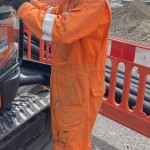 Electical Engineer Lad Wearing Portwest Bizflame Orange Boilersuit 11 Engineer lad replacing street paving that was removed to install a new electricity supply