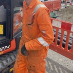 Electical Engineer Lad Wearing Portwest Bizflame Orange Boilersuit 13 Engineer lad replacing street paving that was removed to install a new electricity supply
