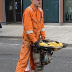 Electical Engineer Lad Wearing Portwest Bizflame Orange Boilersuit 14 Engineer lad replacing street paving that was removed to install a new electricity supply