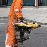 Electical Engineer Lad Wearing Portwest Bizflame Orange Boilersuit 15 Engineer lad replacing street paving that was removed to install a new electricity supply