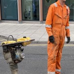 Electical Engineer Lad Wearing Portwest Bizflame Orange Boilersuit 16 Engineer lad replacing street paving that was removed to install a new electricity supply