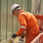 Electical Engineer Lad Wearing Portwest Bizflame Orange Boilersuit 18 Engineer lad replacing street paving that was removed to install a new electricity supply