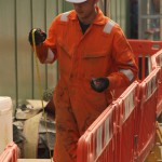 Electical Engineer Lad Wearing Portwest Bizflame Orange Boilersuit 19 Engineer lad replacing street paving that was removed to install a new electricity supply