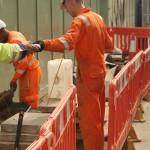 Electical Engineer Lad Wearing Portwest Bizflame Orange Boilersuit 20 Engineer lad replacing street paving that was removed to install a new electricity supply