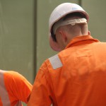 Electical Engineer Lad Wearing Portwest Bizflame Orange Boilersuit 21 Engineer lad replacing street paving that was removed to install a new electricity supply