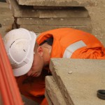 Electical Engineer Lad Wearing Portwest Bizflame Orange Boilersuit 22 Engineer lad replacing street paving that was removed to install a new electricity supply