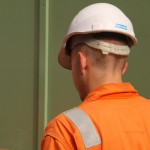 Electical Engineer Lad Wearing Portwest Bizflame Orange Boilersuit 24 Engineer lad replacing street paving that was removed to install a new electricity supply