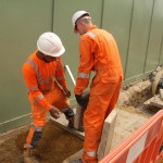 Electical Engineer Lad Wearing Portwest Bizflame Orange Boilersuit 25 Engineer lad replacing street paving that was removed to install a new electricity supply