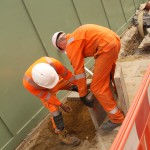 Electical Engineer Lad Wearing Portwest Bizflame Orange Boilersuit 26 Engineer lad replacing street paving that was removed to install a new electricity supply