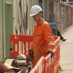 Electical Engineer Lad Wearing Portwest Bizflame Orange Boilersuit 29 Engineer lad replacing street paving that was removed to install a new electricity supply