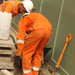 Electical Engineer Lad Wearing Portwest Bizflame Orange Boilersuit 2 Engineer lad replacing street paving that was removed to install a new electricity supply