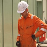 Electical Engineer Lad Wearing Portwest Bizflame Orange Boilersuit 30 Engineer lad replacing street paving that was removed to install a new electricity supply