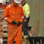 Electical Engineer Lad Wearing Portwest Bizflame Orange Boilersuit 31 Engineer lad replacing street paving that was removed to install a new electricity supply