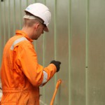 Electical Engineer Lad Wearing Portwest Bizflame Orange Boilersuit 32 Engineer lad replacing street paving that was removed to install a new electricity supply