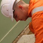 Electical Engineer Lad Wearing Portwest Bizflame Orange Boilersuit 4 Engineer lad replacing street paving that was removed to install a new electricity supply