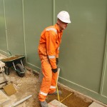 Electical Engineer Lad Wearing Portwest Bizflame Orange Boilersuit 5 Engineer lad replacing street paving that was removed to install a new electricity supply