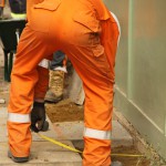 Electical Engineer Lad Wearing Portwest Bizflame Orange Boilersuit 6 Engineer lad replacing street paving that was removed to install a new electricity supply