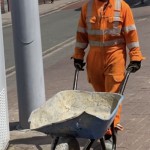 Road workers wearing orange hi-vis boilersuits and coveralls