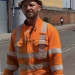 Road workers wearing orange hi-vis boilersuits and coveralls