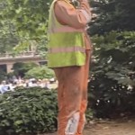Road workers wearing various orange hi-vis boilersuits and coveralls