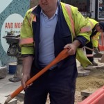 Road workers wearing orange hi-vis boilersuits and coveralls