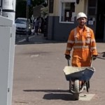 Road workers wearing orange hi-vis boilersuits and coveralls